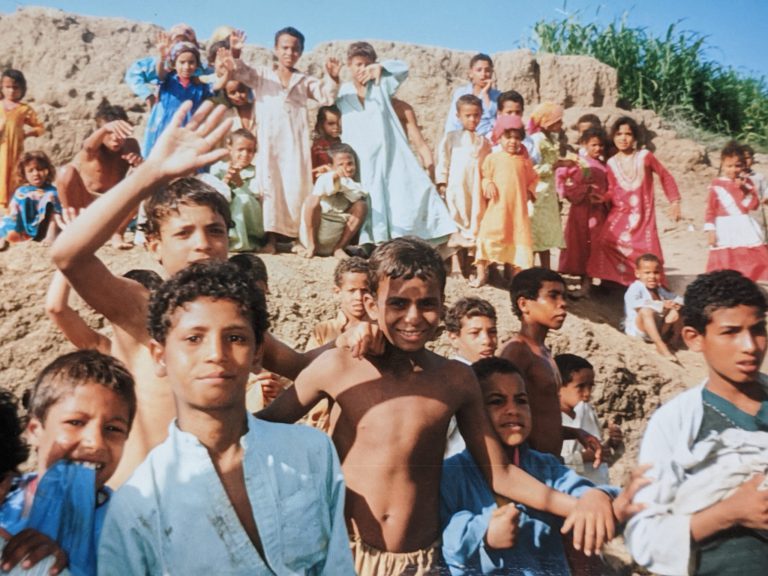 Crowds of children on banks of Nile, travel tales