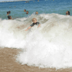 Boy in waves, Lagos, Portugal, travel tales