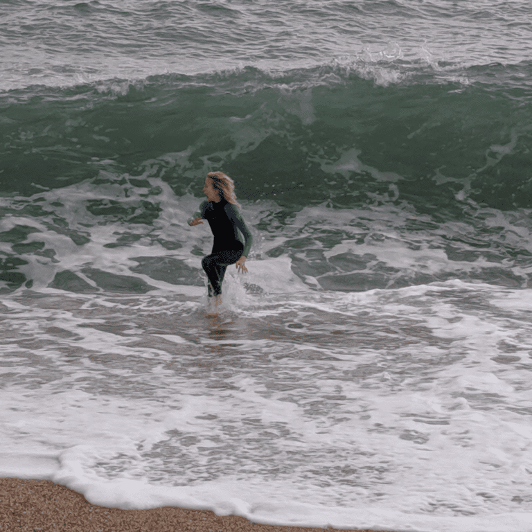 Boy in waves, Blackpool Sands, Devon, UK,, travel tales
