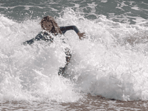 Boy in waves, Blackpool Sands, Devon, UK,, travel tales