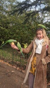 Feeding the parakeets in Hyde Park, London itinerary with kids